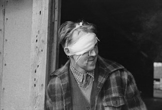 Lumberjack with Bandaged Head after Being Beaten up and Robbed in Saloon, Craigville, Minnesota, USA, Russell Lee, September 1937
