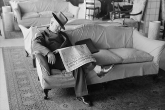 Man Falling Asleep while Reading Newspaper in Hotel Lobby, Taylor, Texas, Russell Lee, November 1939
