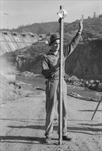 Rod Man with Surveying Crew, Shasta Dam, Shasta County, California, USA, Russell Lee, December 1941