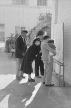 Japanese-Americans Reading Evacuation Orders on Bulletin Board at Mary Knoll Mission