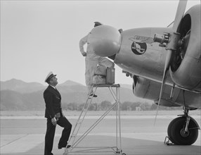 Plant Quarantine Inspectors Examining Airplane at Airport, Glendale, California, USA, Dorothea Lange for Farm Security Administration, May 1937