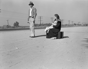 Penniless and Homeless Young Family Hitchhiking, U.S. Highway 99, California, USA, Dorothea Lange for Farm Security Administration, November 1936
