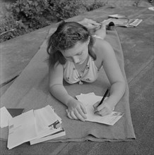 Young Girl Writing to Boyfriend Back Home while Away at Summer National Music Camp, Interlochen, Michigan, USA, Arthur S. Siegel for Office of War Information, August 1942