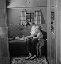 Father with Two Children in Trailer Home at Glenn L. Martin Trailer Village, a Farm Security Administration (FSA) Housing Project, Middle River, Maryland, USA, John Collier for Office of War Informati...