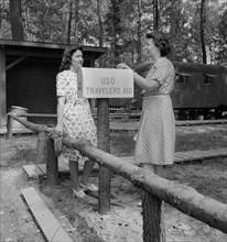 United Service Organization (USO) Traveler's Aide Giving Information to Newcomer in Glenn L. Martin Trailer Village, a Farm Security Administration (FSA) Housing Project, Middle River, Maryland, USA, ...