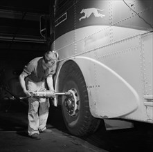 Mechanic Removing Tire from Bus at Greyhound Garage, Pittsburgh, Pennsylvania, USA, Esther Bubley for Office of War Information, September 1943