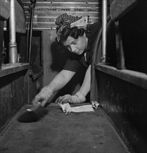Charwoman Sweeping Floor of Bus, Pittsburgh, Pennsylvania, USA, Esther Bubley for Office of War Information, September 1943