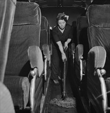 Charwoman Mopping Floor of Bus at Greyhound Garage, Pittsburgh, Pennsylvania, Esther Bubley for Office of War Information, September 1943