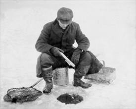 Man Fishing Through Hole in Ice, Bain News Service, circa 1910