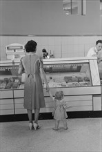 Mother with Child Shopping in Co-Op Store, Greenbelt, Maryland, USA, Marion Post Wolcott for Farm Security Administration, September 1938