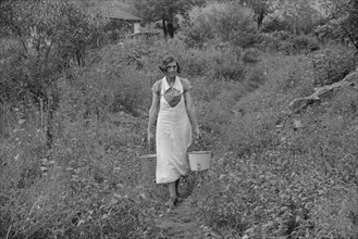 Coal Miner's Wife Carrying Water Home from the Hill, Bertha Hill, West Virginia, USA, Marion Post Wolcott for Farm Security Administration, September 1938