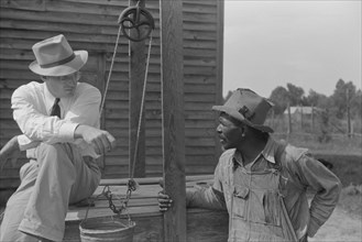 Farm Security Administration (FSA) Supervisor Inspecting Rehabilitation Borrower's Well, Greene County, Georgia, USA, Marion Post Wolcott for Farm Security Administration, June 1939
