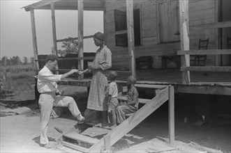 Public Health Doctor giving Tenant Family Medicine for Malaria, near Columbia, South Carolina, USA, Marion Post Wolcott for Farm Security Administration, June 1939