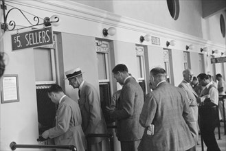 Group of Men Waging Bets on Horse Race at Betting Windows, Hialeah Park, Miami, Florida, USA, Marion Post Wolcott for Farm Security Administration, March 1939