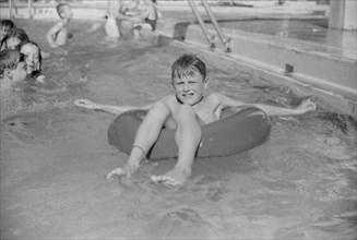 Young Boy on Float in Public Swimming Pool, Greenbelt, Maryland, USA, Marion Post Wolcott for Farm Security Administration, August 1939