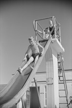 Children on Slide at Public Swimming Pool, Greenbelt, Maryland, USA, Marion Post Wolcott for Farm Security Administration, August 1939