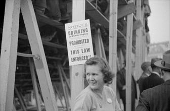 Woman Standing Near No Drinking Sign Posted at Duke University-North Carolina Football Game, Durham, North Carolina, USA, Marion Post Wolcott for Farm Security Administration, November 1939