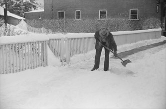 Man Clearing Snow from Sidewalk after Heavy Snowfall, Woodstock, Vermont, USA, Marion Post Wolcott for Farm Security Administration, March 1940