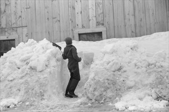 Young Boy Shoveling Snow from Barn Window after Heavy Snowfall, near Woodstock, Vermont, USA, Marion Post Wolcott for Farm Security Administration, April 1940