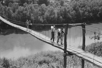 Family Carrying Home Groceries and Supplies Across Swinging Footbridge over River, near Jackson, Kentucky, Marion Post Wolcott for Farm Security Administration, August 1940