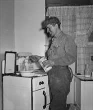 Coal Miner Making Breakfast at Home after Returning from Night Shift Work, Westover, West Virginia, USA, Marion Post Wolcott for Farm Security Administration, September 1938