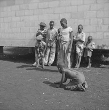 Children Playing Marbles, Okeechobee Migratory Labor Camp, Belle Glade, Florida, USA, Marion Post Wolcott for Farm Security Administration, June 1940