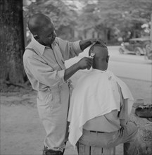 Barber Cutting Man's Hair, Natchez, Mississippi, USA, Marion Post Wolcott for Farm Security Administration, August 1940