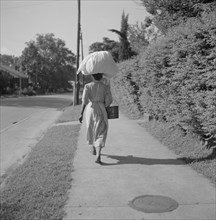 Woman Carrying Sack of Laundry on her Head, Rear View, Natchez, Mississippi, USA, Marion Post Wolcott for Farm Security Administration, August 1940