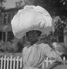 Portrait of Woman Carrying Sack of Laundry on her Head, Natchez, Mississippi, USA, Marion Post Wolcott for Farm Security Administration, August 1940