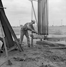 Man Servicing Old Oil Well, near Wichita, Kansas, USA, Marion Post Wolcott for Farm Security Administration, September 1941