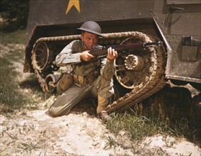 Young Soldier Aiming Garland Rifle near Armored Tank, Fort Knox, Kentucky, USA, Alfred T. Palmer for Office of War Information, June 1942