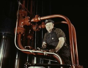 Maintenance Mechanic in Largest Coal Press in World, Combustion Engineering Company, Chattanooga, Tennessee, USA, Alfred T. Palmer for Office of War Information, June 1942