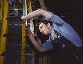 Man Assembling Wing Brace for B-25 Bomber on Assembly Line at Aircraft Plant, California, USA, Afred T. Palmer for Office of War information, 1942