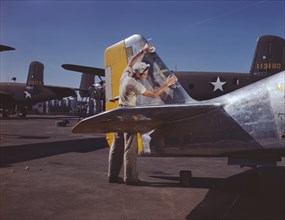 Painter Cleaning Tail Section of P-51 Fighter Plane on Outdoor Assembly Line Prior to Spraying Olive-Drab Camouflage of U.S. Army, North American Aviation, Inc, Inglewood, California, USA, Alfred T. P...