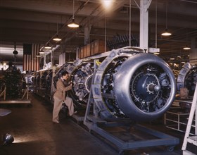 Worker Adding Cowling and Control Rods to Motors of B-25 Bombers on Assembly Line, North American Aviation Plant, Inglewood, California, USA, Alfred T. Palmer for Office of War Information, October 19...