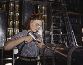 Female Worker Operating Hand Drill, North American Aviation, Inc, Inglewood, California, USA, Alfred T. Palmer for Office of War Information, October 1942