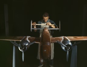 Worker Preparing Experimental Scale Model of B-25 Airplane for Wind Tunnel Tests, North American Aviation Plant, Inglewood, California, USA, Alfred T. Palmer for Office of War Information, October 194...