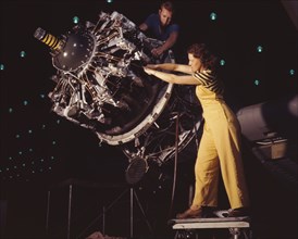 Woman Being Trained to do Vital Aircraft Engine Installation, Douglas Aircraft Company, Long Beach, California, USA, Alfred T. Palmer for Office of War Information, October 1942