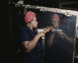 Female Worker Operating Hand Drill on Vultee "Vengeance" A-31 Dive Bomber, Nashville, Tennessee, USA, Alfred T. Palmer for Office of War Information, February, 1943