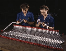 Two Female Workers Capping and Inspecting Tubing for Vultee "Vengeance" A-31 Dive Bomber, Nashville, Tennessee, USA, Alfred T. Palmer for Office of War Information, February, 1943