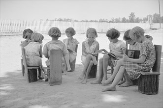 Young Girls Reading Books in Schoolyard, Cumberland Mountain Farms, near Scottsboro, Alabama, USA, Carl Mydans for U.S. Resettlement Administration, June 1936
