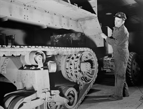 Worker Lowering Partly-finished Halftrac Scout Car Body on Chassis at War Plant that Formerly Produced Locks and Safes, Diebold Safe and Lock Company, Canton, Ohio, USA, Alfred T. Palmer for Office of...