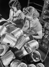 Two Female Workers Inspecting Heat-Treated Pistons prior to Brinnell hardness Testing at Aluminum Factory Converted to War Production, Aluminum Industries, Inc., Cincinnati, Ohio, USA, Alfred T. Palme...