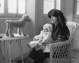 Mrs. P.A. Drury and Infant Child Staring at Stuffed Toy Dog, National Photo Company, 1922