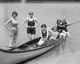 Actress Kay Laurel (seated with hat) and Group of Women in Bathing Suits Posing with Canoe at Bathing Beach, Washington DC, USA, National Photo Company, July 1922