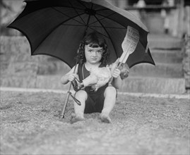 Young Girl in Bathing Suit Holding Doll and Sun Umbrella, National Photo Company, June 1923