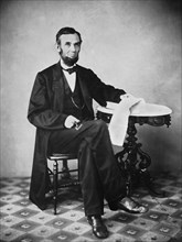 U.S. President Abraham Lincoln, Portrait, Seated next to Table, Washington DC, USA, by Alexander Gardner, August 1863