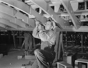 Carpenter Building Torpedo Boats at Shipyard during WWII, New Orleans, Louisiana, USA, Howard R. Hollem for Office of War Information, July 1942