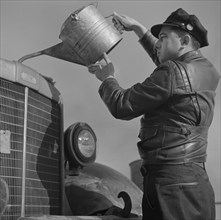 Truck Driver Putting Water in Radiator Along U.S. Highway 29, North Carolina, USA, John Vachon for Office of War Information, March 1943