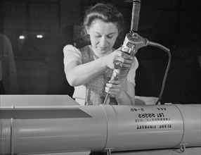 Female Factory Worker, Assembling Flare Casings in Support of War Effort, A.C. Gilbert Company, New Haven, Connecticut, USA, Howard R. Hollem for Office of War Information, February 1942